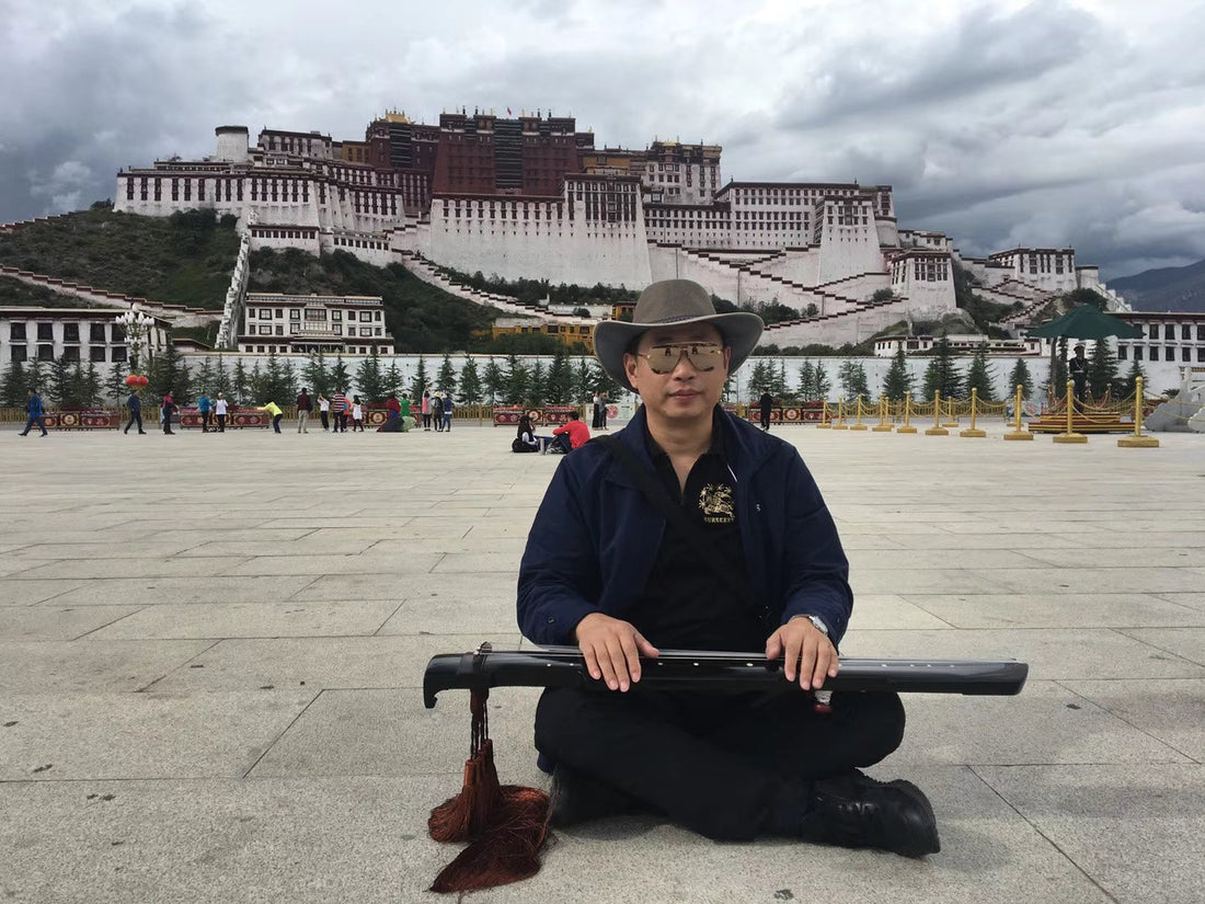 William Xu sits cross-legged on the stone square before the Potala Palace in Lhasa, Tibet, holding his guqin — the beginning of a decade-long journey playing the ancient instrument at the highest places on earth.