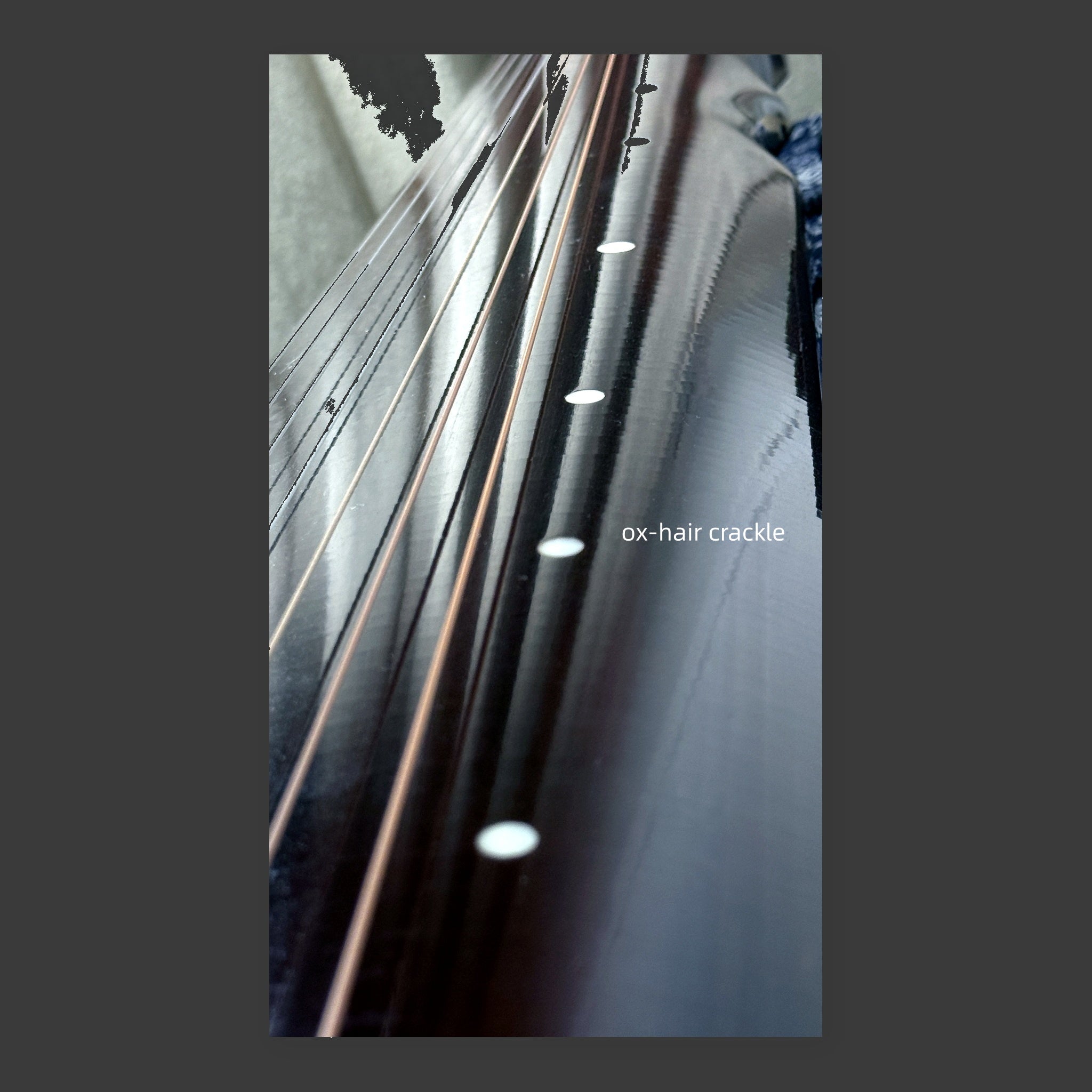 Jiuxiao Huanpei guqin – close-up of seven strings and hui position markers