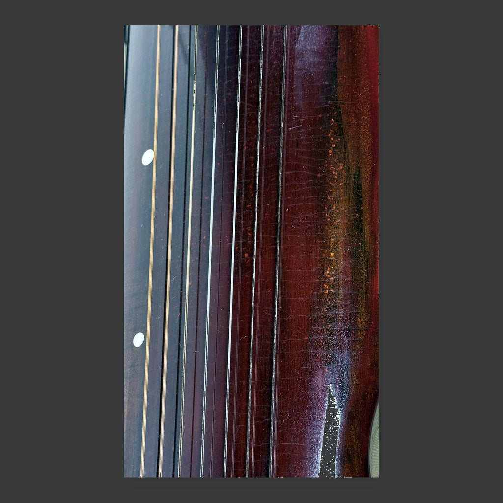 Jiuxiao Huanpei guqin – close-up of lower end with strings and silk finish