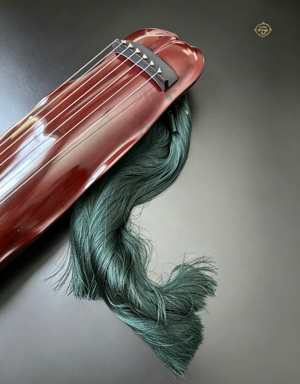 Banana Leaf guqin – full body with green silk tassel flowing beside instrument