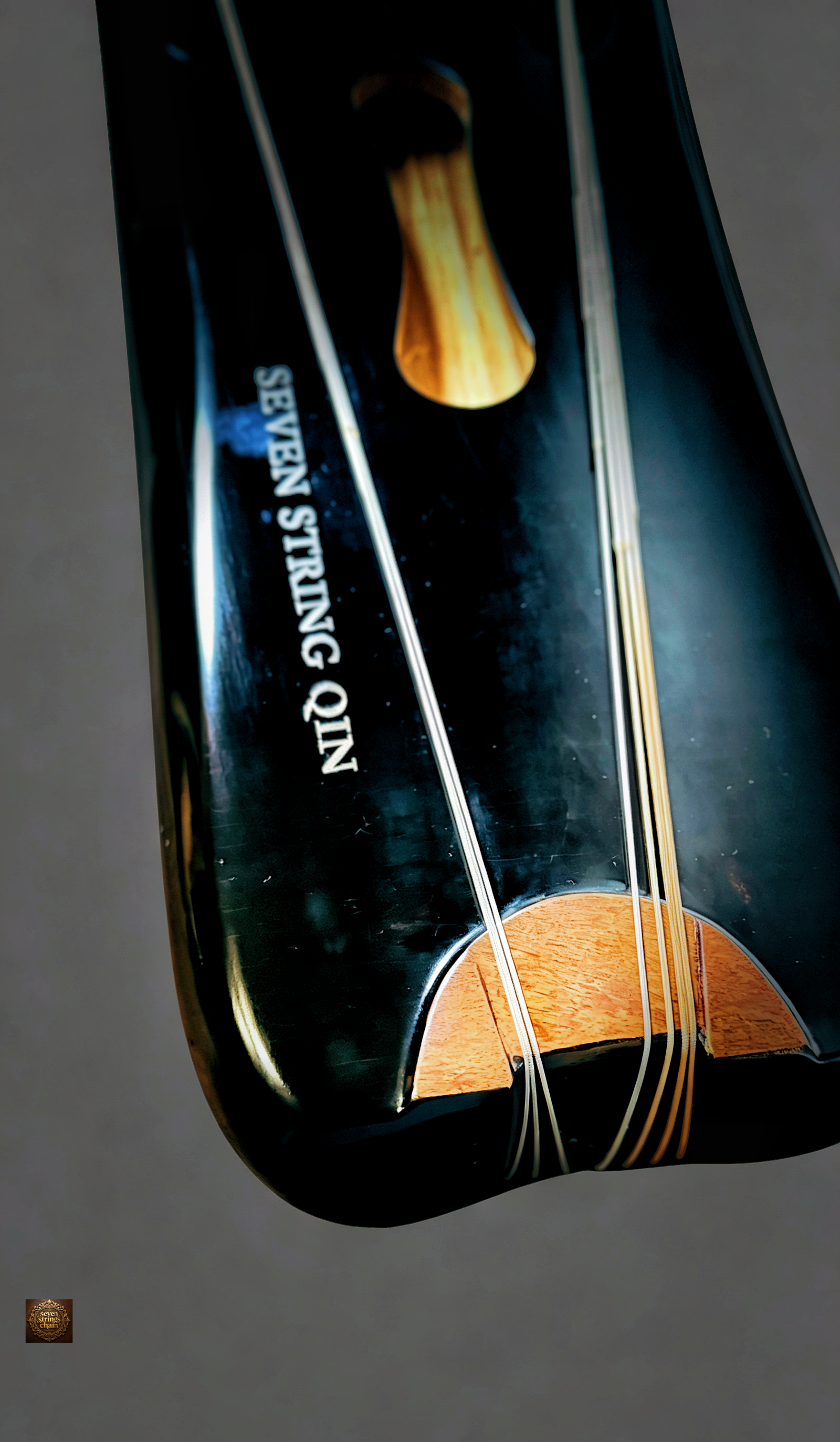 Jiaolin Tingyu Guqin – close-up of lower end with "Seven String Qin" brand engraving and strings
