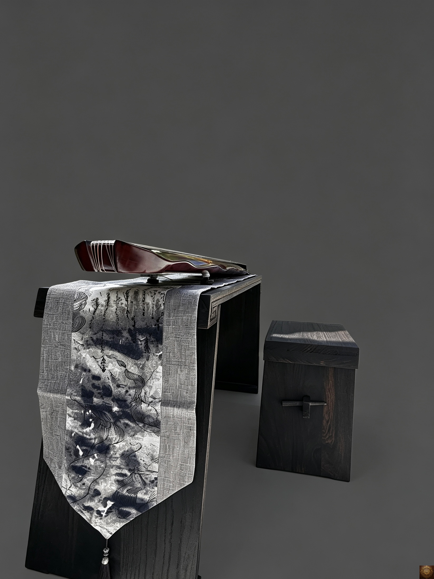 Detachable guqin table – close-up of guqin tail end showing seven tuning pegs and green silk tassels draped over grey linen table runner